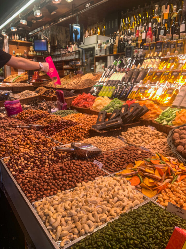 A market in Barcelona with stalls of fruit and nuts.